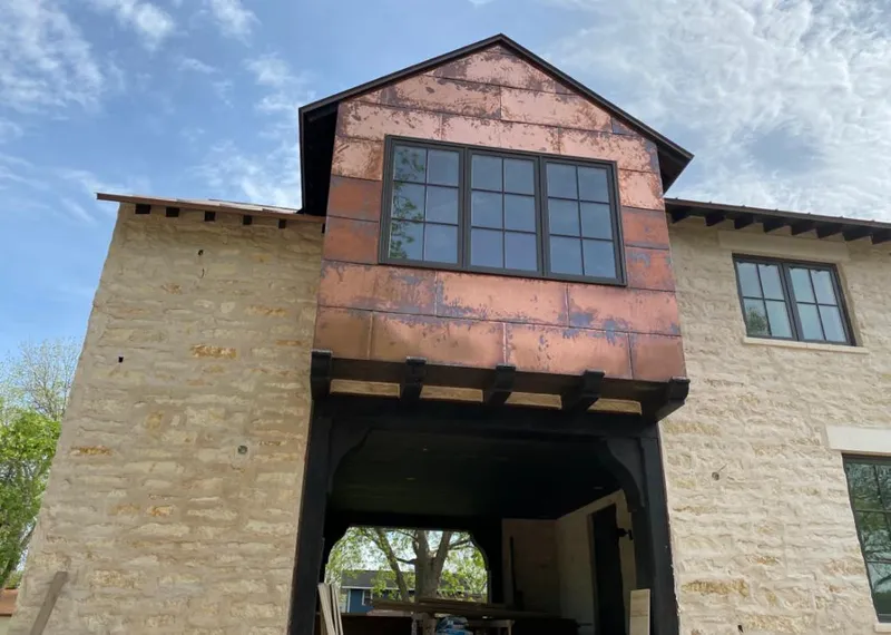 Copper metal panel facade on a stone building for Skylight Installation in Dunellen